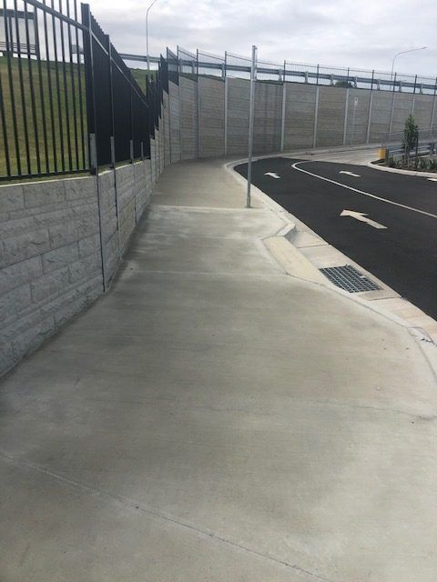 A Sidewalk Leading To A Road With An Arrow Pointing To The Right — Tuscany Concreting In Whitsundays, QLD