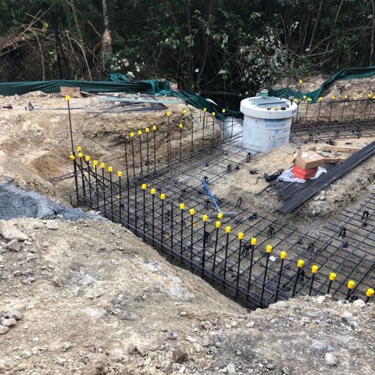A Fence Is Being Built Around A Hole In The Ground — Tuscany Concreting In Proserpine, QLD