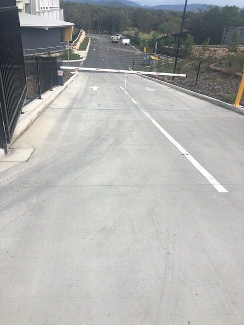 A Concrete Road With A White Line On It — Tuscany Concreting In Cannonvale, QLD