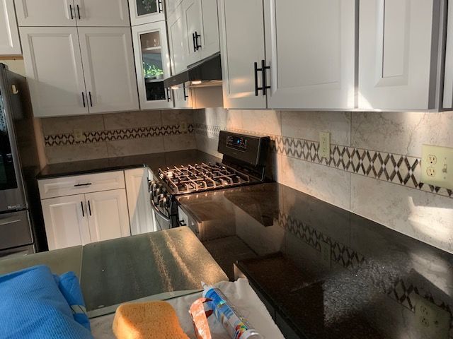 White cabinets and dark countertop in kitchen