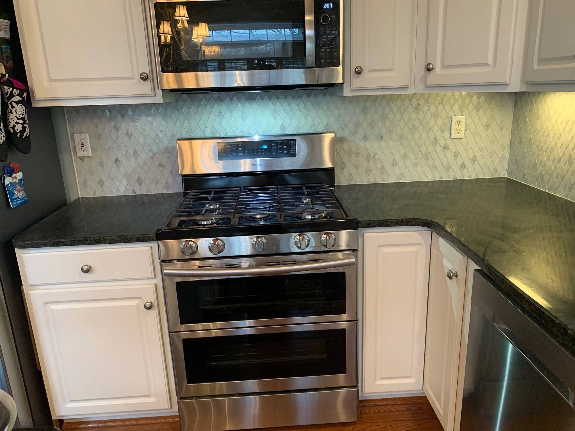Stainless steel oven and microwave in kitchen