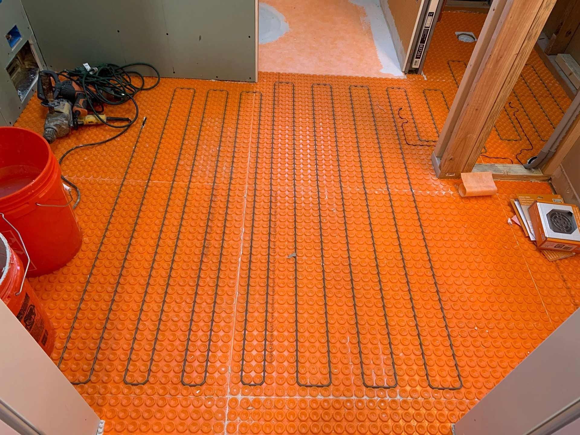 Radiant floor heating mat in bathroom during construction