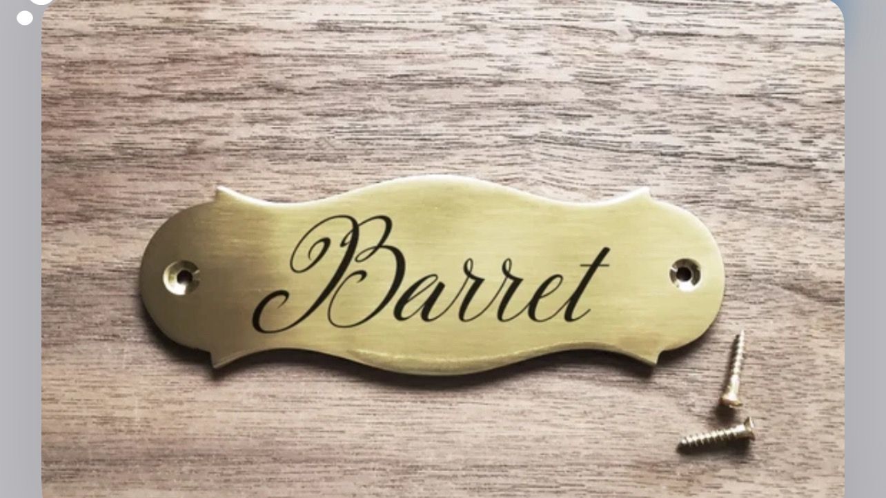 A brass nameplate engraved with the name 