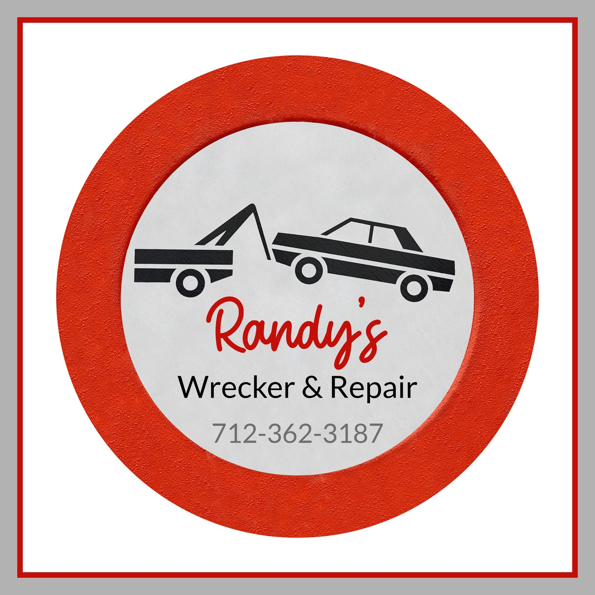 Randy's Wrecker & Repair logo: tow truck towing a car. Red and white circle with phone number.