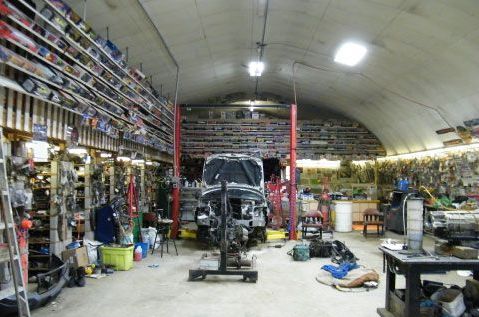 A car is sitting on a lift in a garage