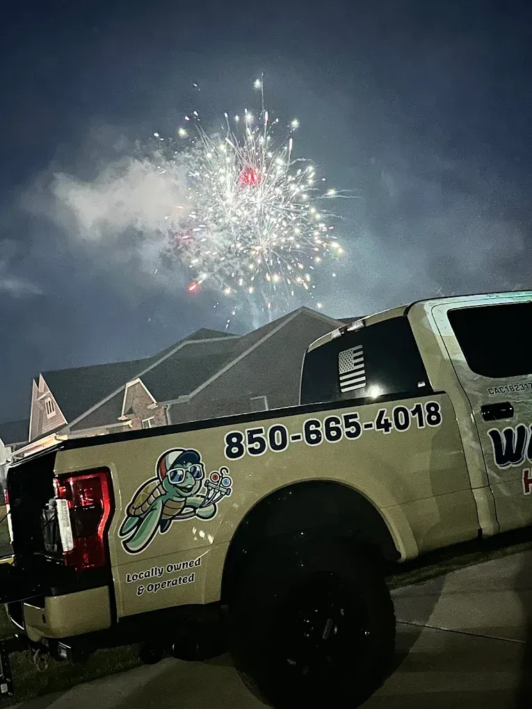 Truck with business logo watching fireworks at night.