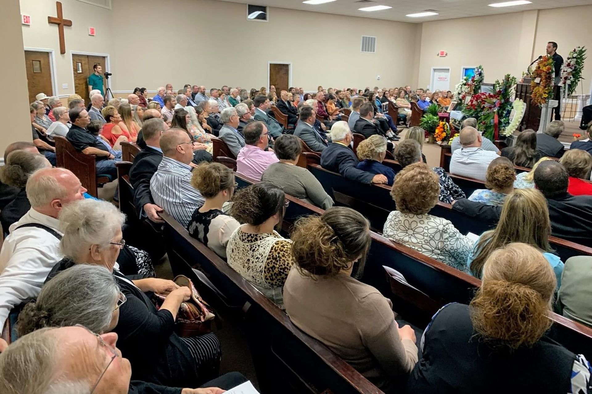 A large group of people are sitting in a church.