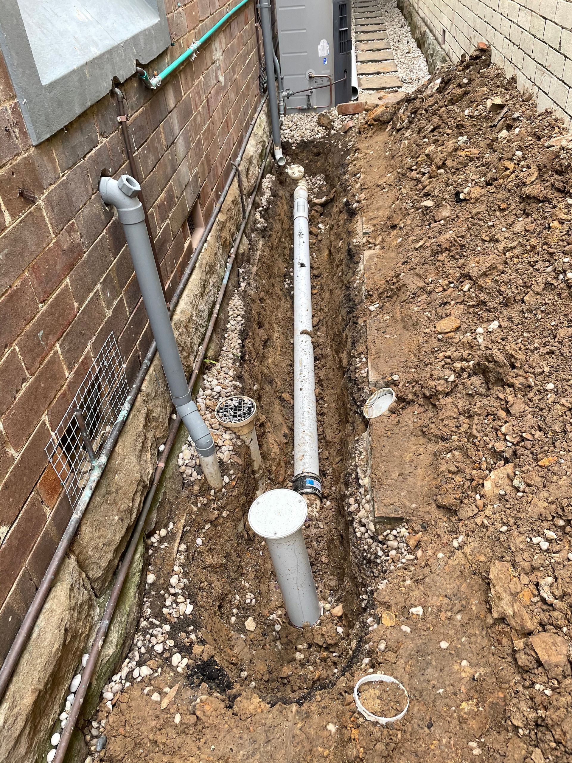 Trench Dug Along a Brick Wall — Start 2 Finish Plumbing in Miranda, NSW
