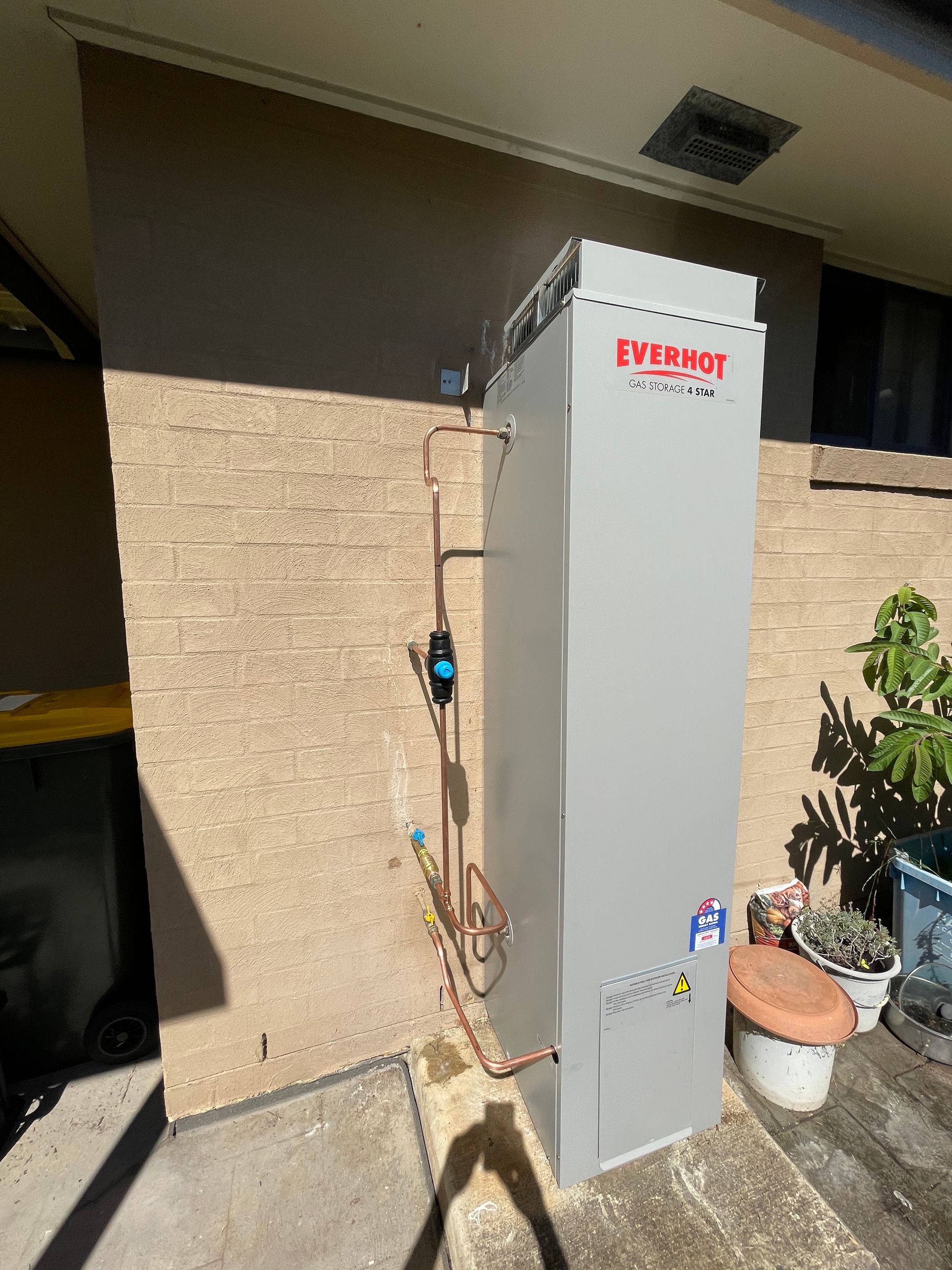 Tall, Gray Everhot Water Heater Stands Outside — Start 2 Finish Plumbing in Yagoona, NSW