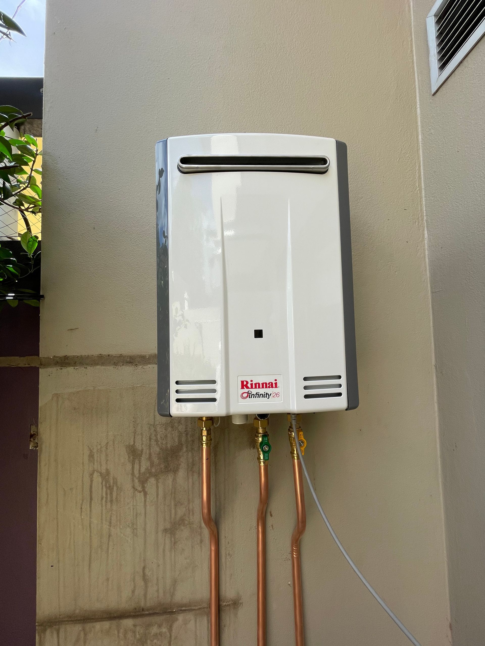 Wall-mounted, White Rinnai Tankless Water Heater — Start 2 Finish Plumbing in Yagoona, NSW