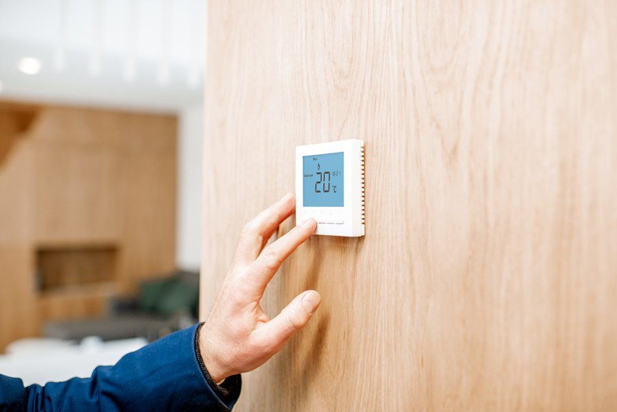 Programmable Thermostat — Man Adjusting Home  Smart Screen in Knoxville, TN