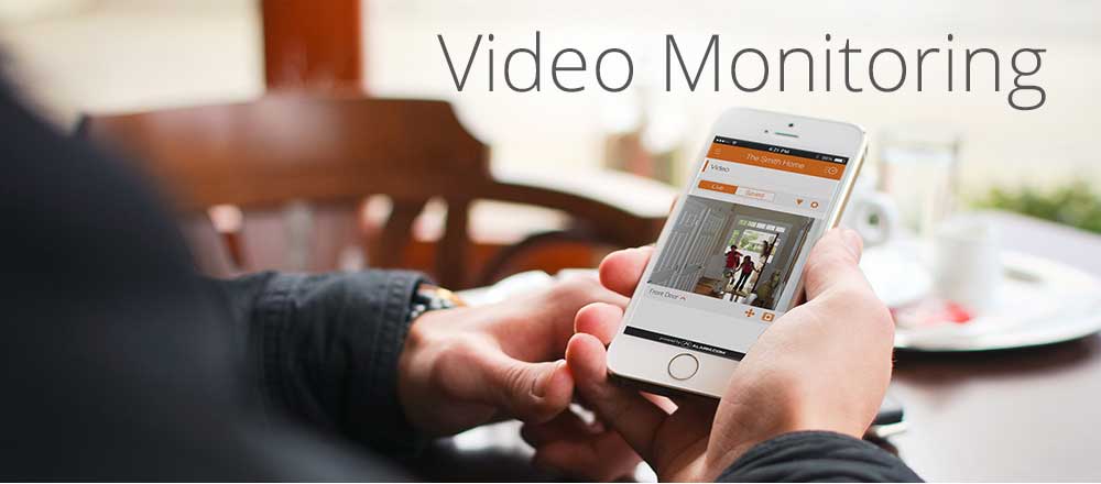 Video Monitoring Service — Man Watching Security Video Record Through Smart Phone in Knoxville, TN