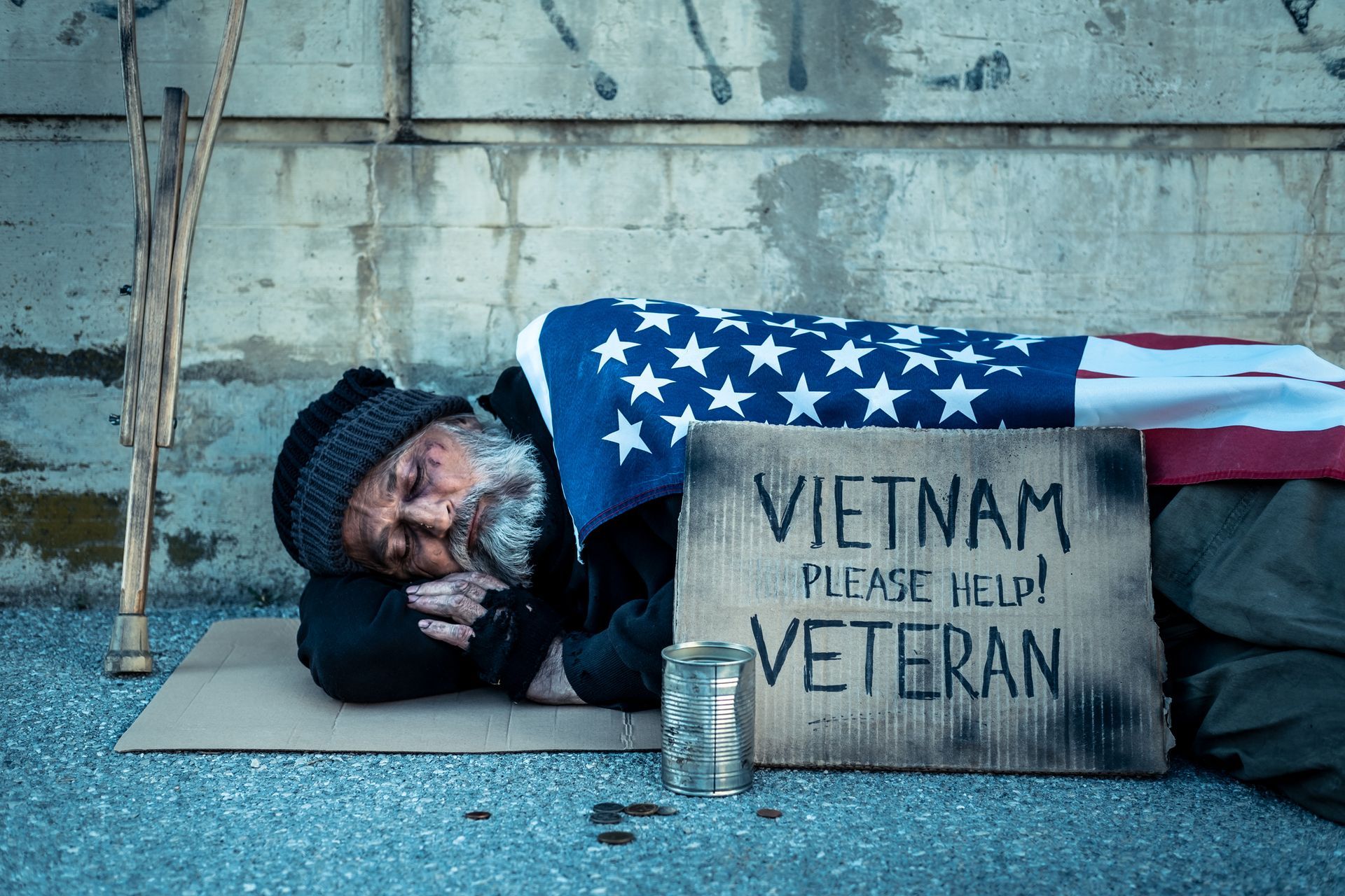 Soldier in uniform holds a smiling child outside a house.