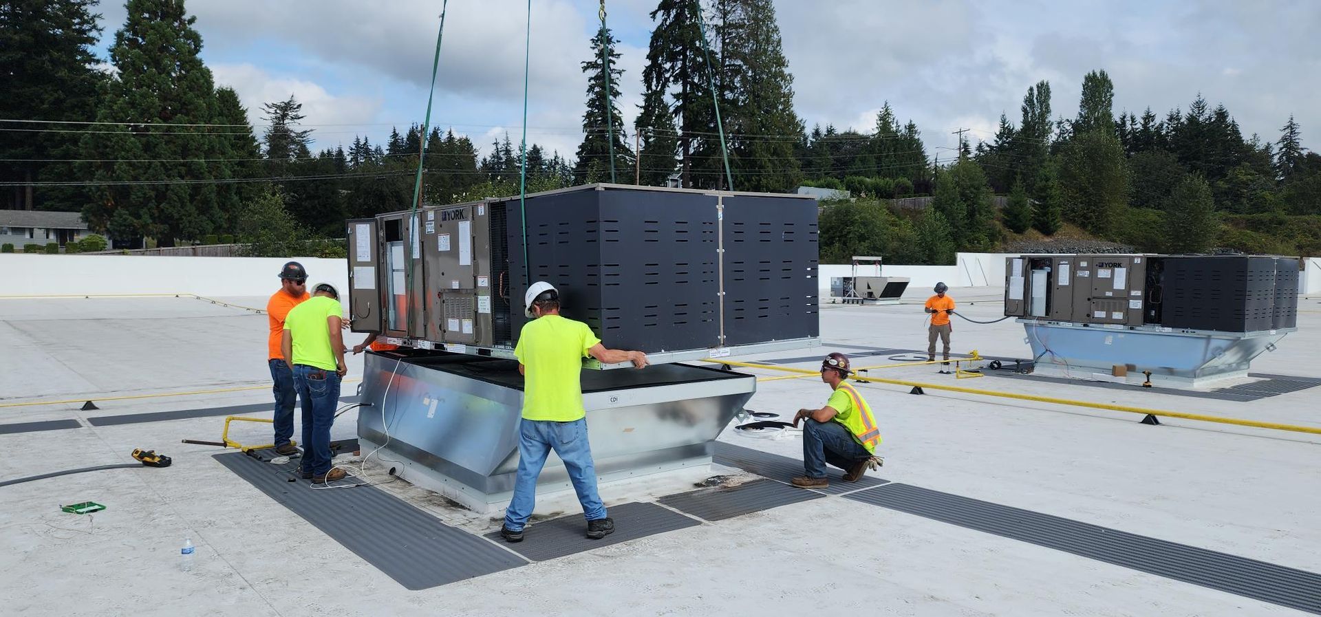 A group of men are working on a roof.