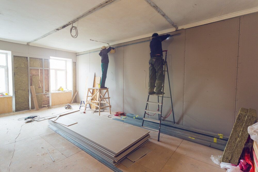 Two Men Are Working On A Wall In A Room — Greg Pollard Building In Pottsville, NSW