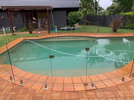 Frameless glass fencing for tiled pool