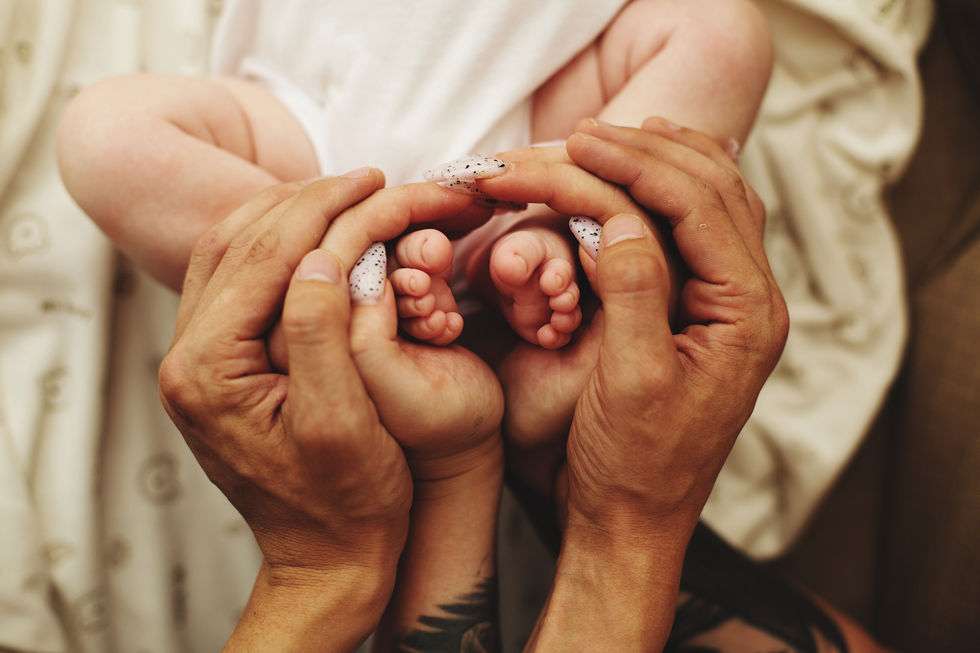 A family walks outdoors, holding hands. The child looks back at the camera.