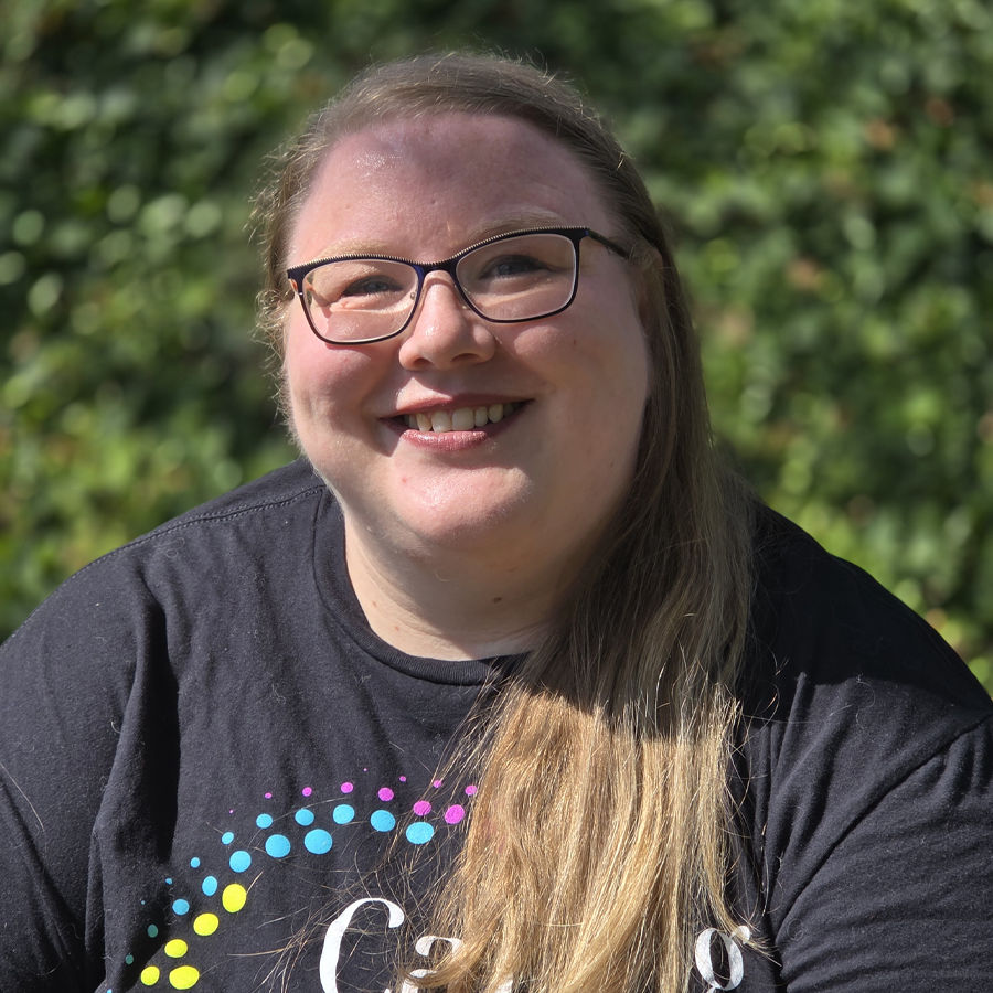 Man smiling, wearing a black shirt with 