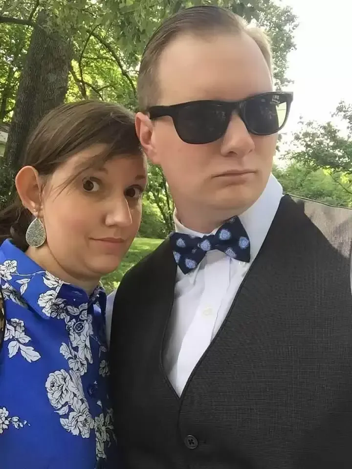 A woman and a man smiling at the camera.