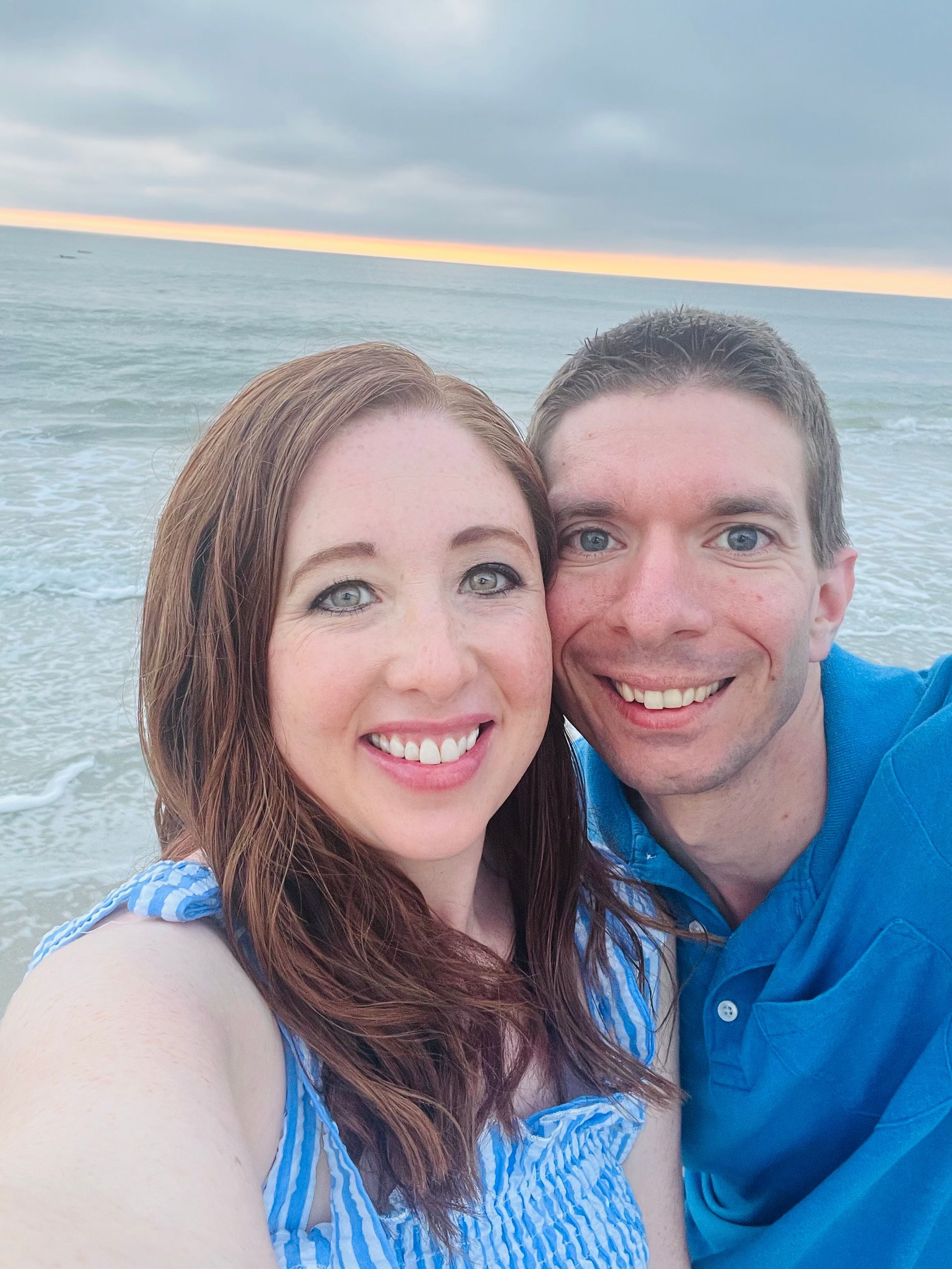 Family posing in front of Cinderella Castle at Disney World.