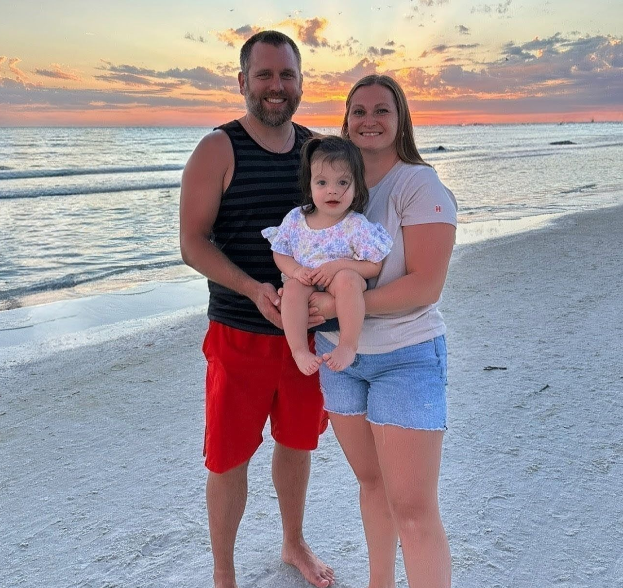 Family posing in front of Cinderella Castle at Disney World.