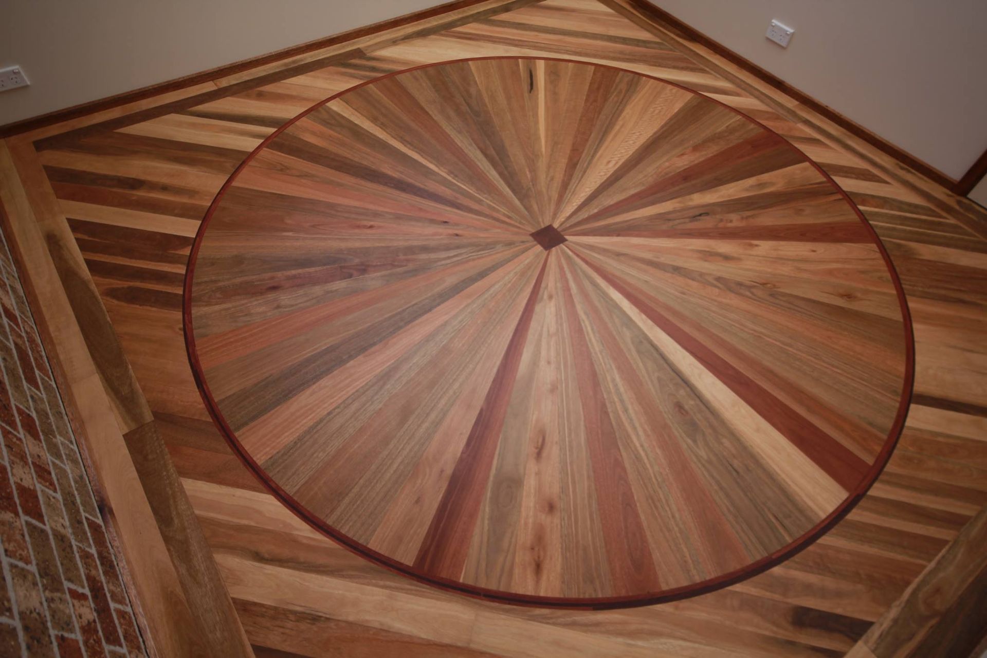 A wooden floor with a circular design on it
