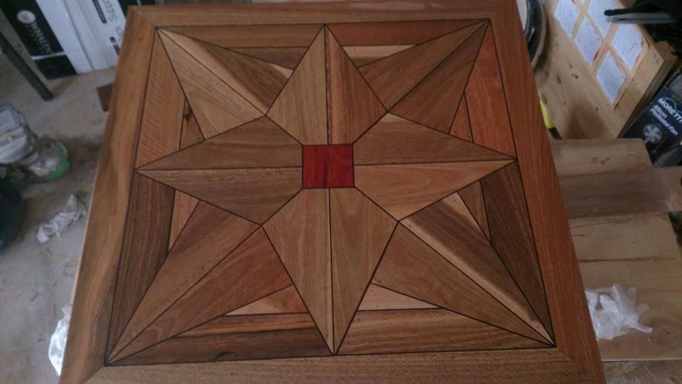 A wooden table with a star pattern on it