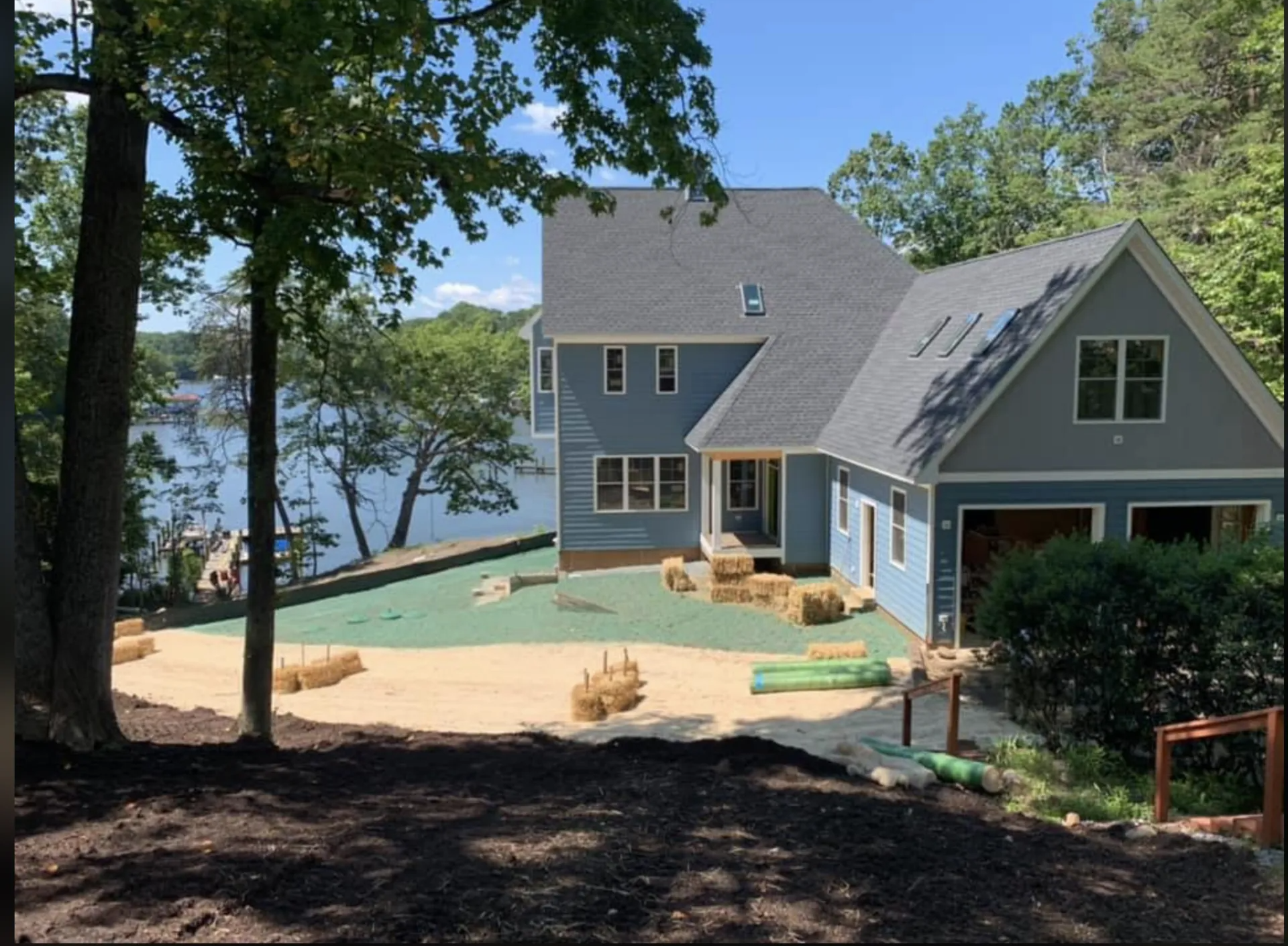 A waterfront house with landscaping.