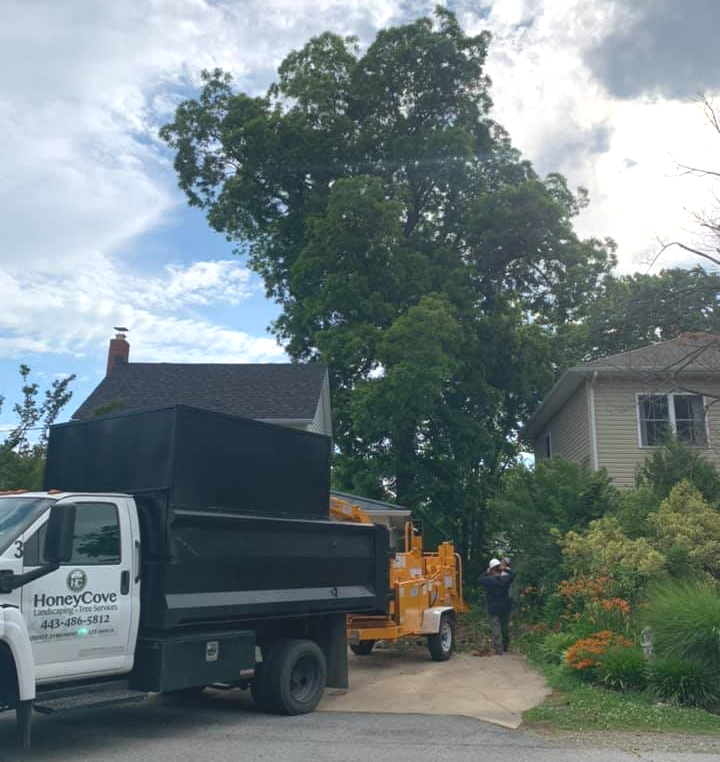 A dump truck is parked in front of a house