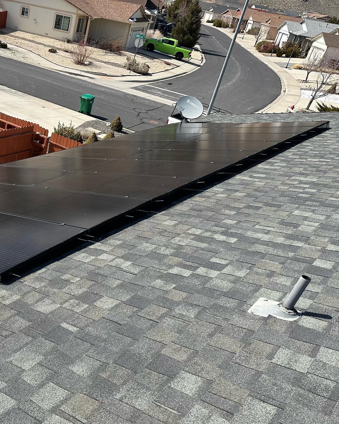 A row of solar panels are sitting on top of a roof.