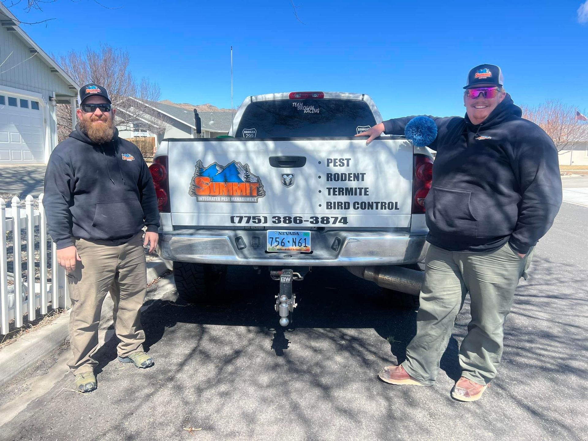 Two men are standing in front of a truck.