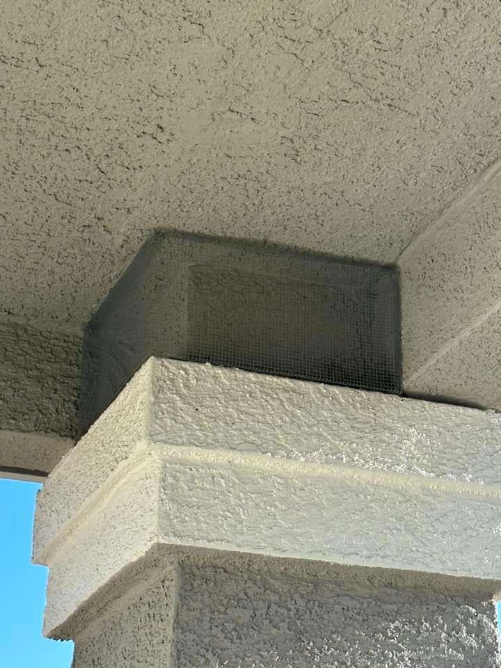A close up of a concrete pillar with a blue sky in the background
