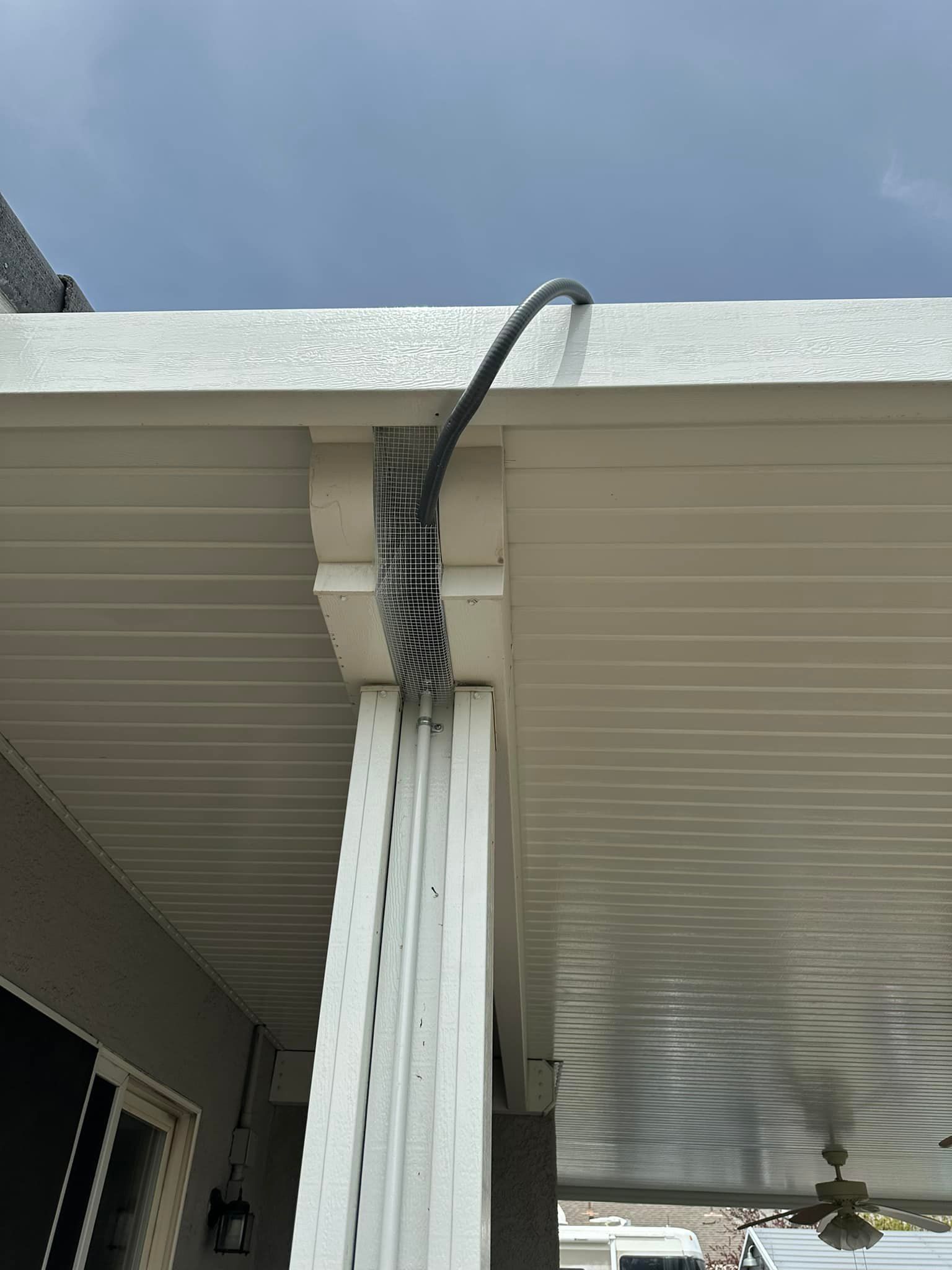A white roof with a black cord hanging from it.