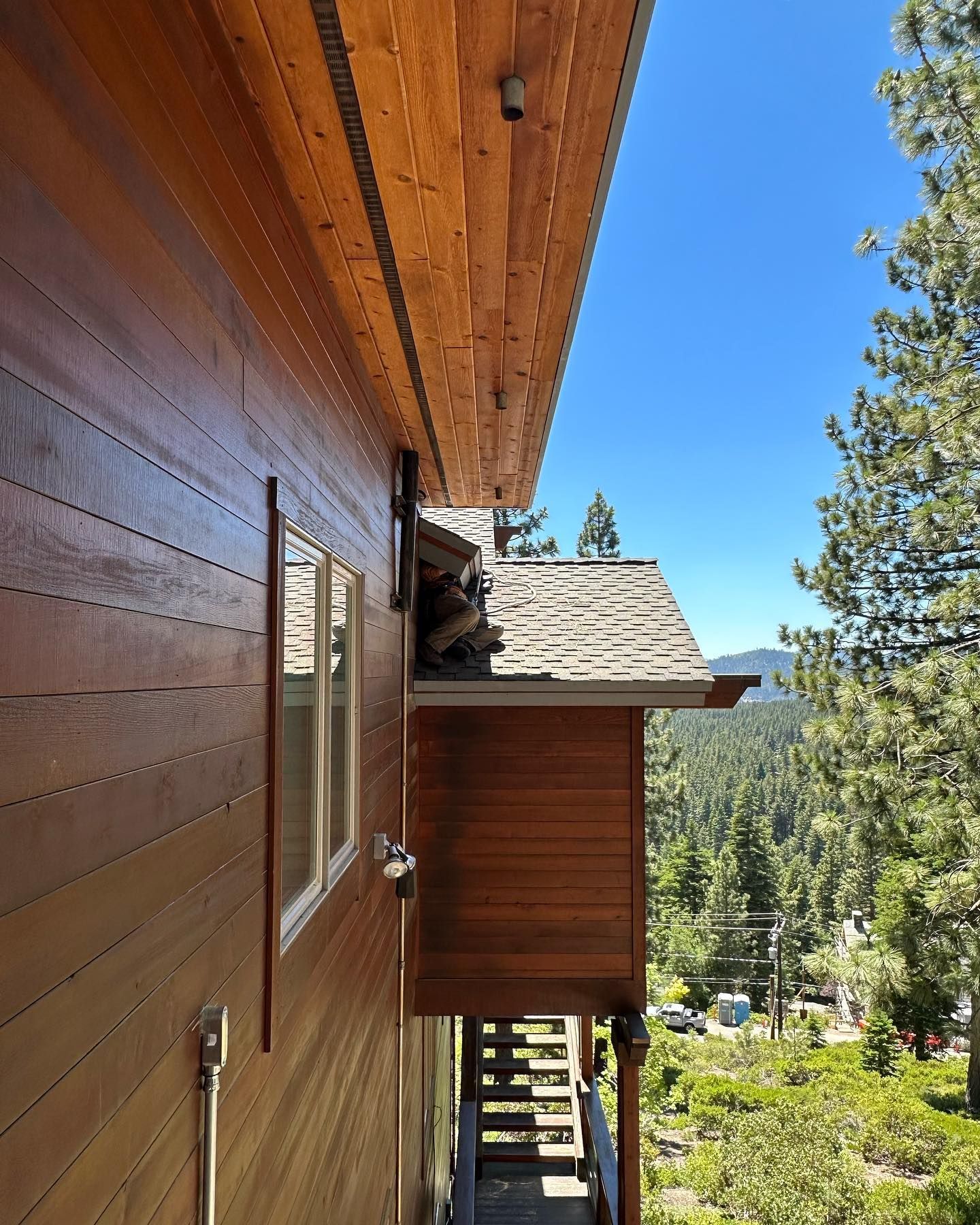 A wooden house with stairs leading up to it