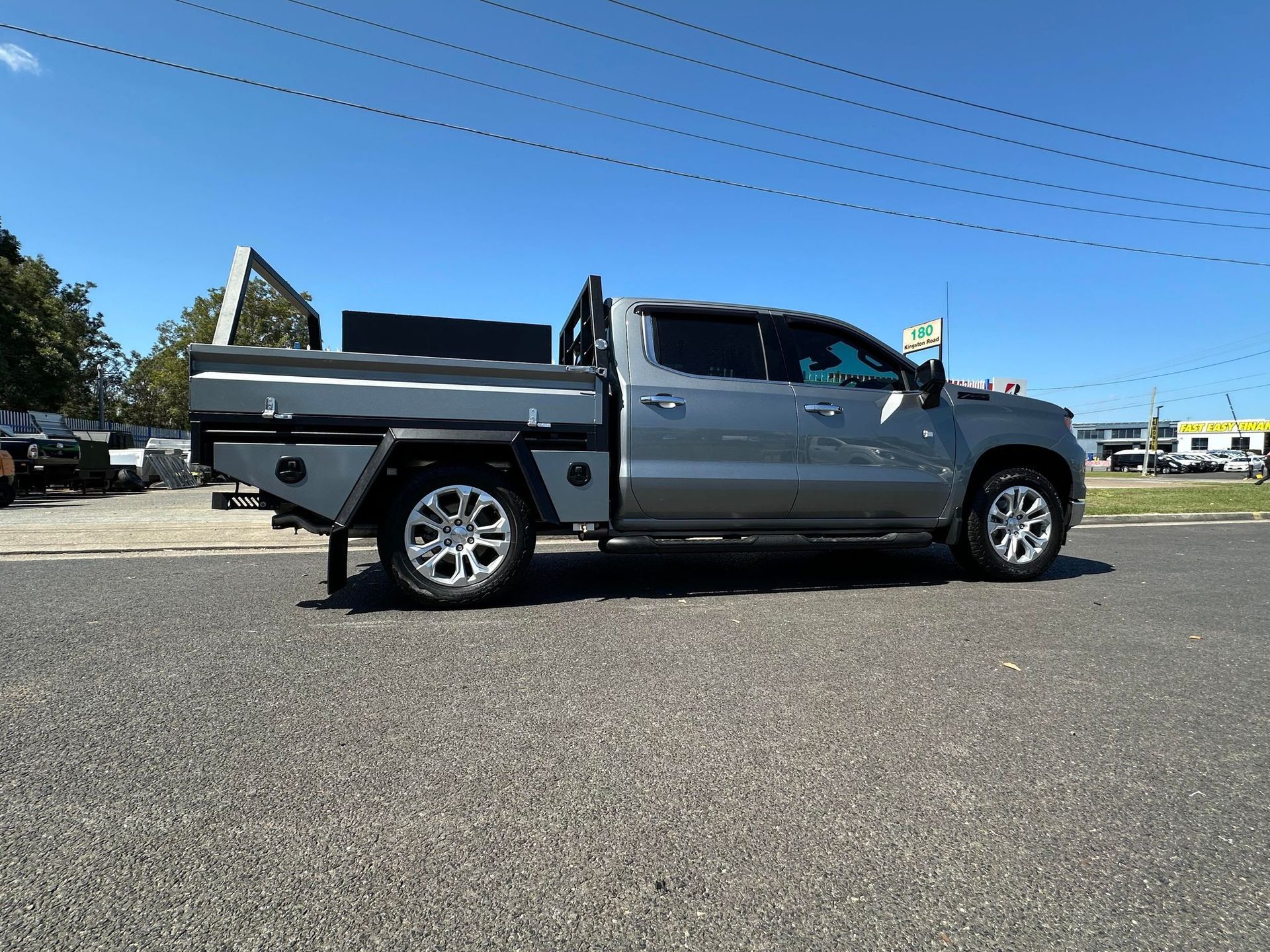 Gray Pickup Truck With a Flatbed Parked on Asphalt Under a Clear Blue Sky — PT Canopy In Slacks Creek, QLD