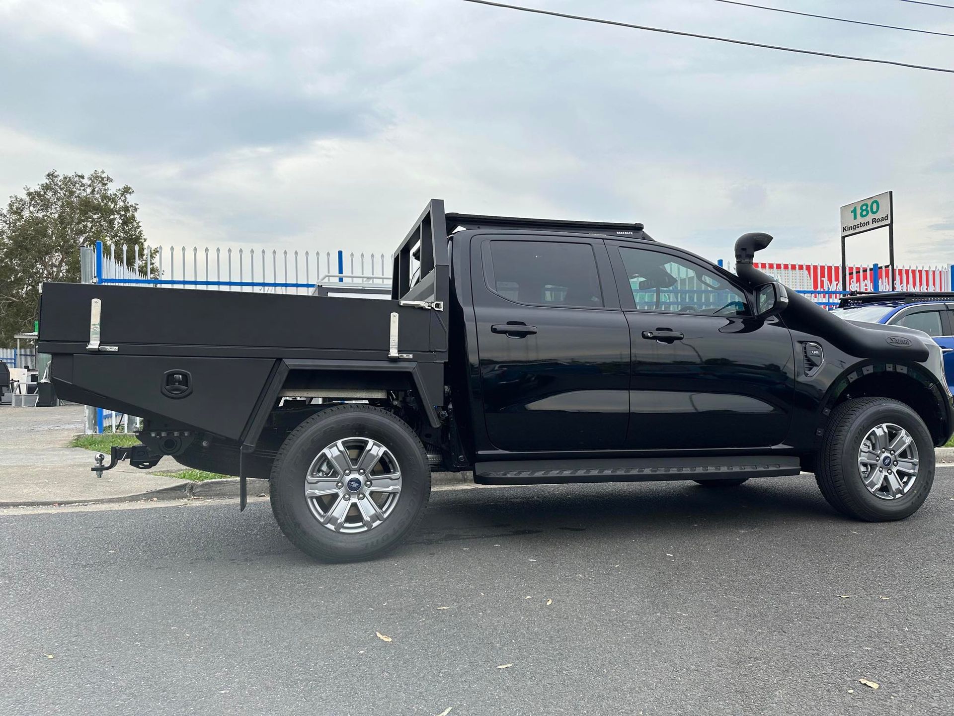 Black Utility Truck With a Flatbed in Front — PT Canopy In Slacks Creek, QLD