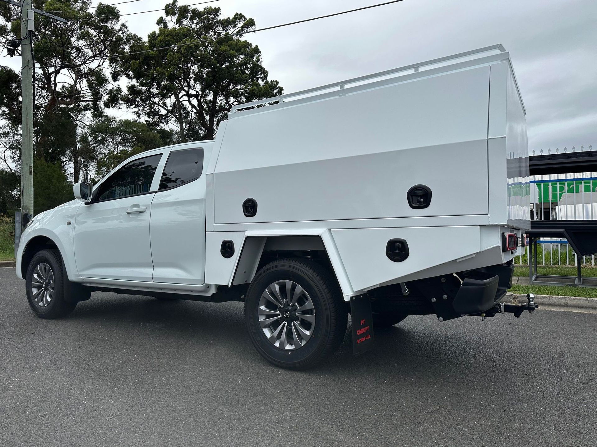 White Pickup Truck With a Large Service Body Parked on a Paved Road — PT Canopy In Slacks Creek, QLD