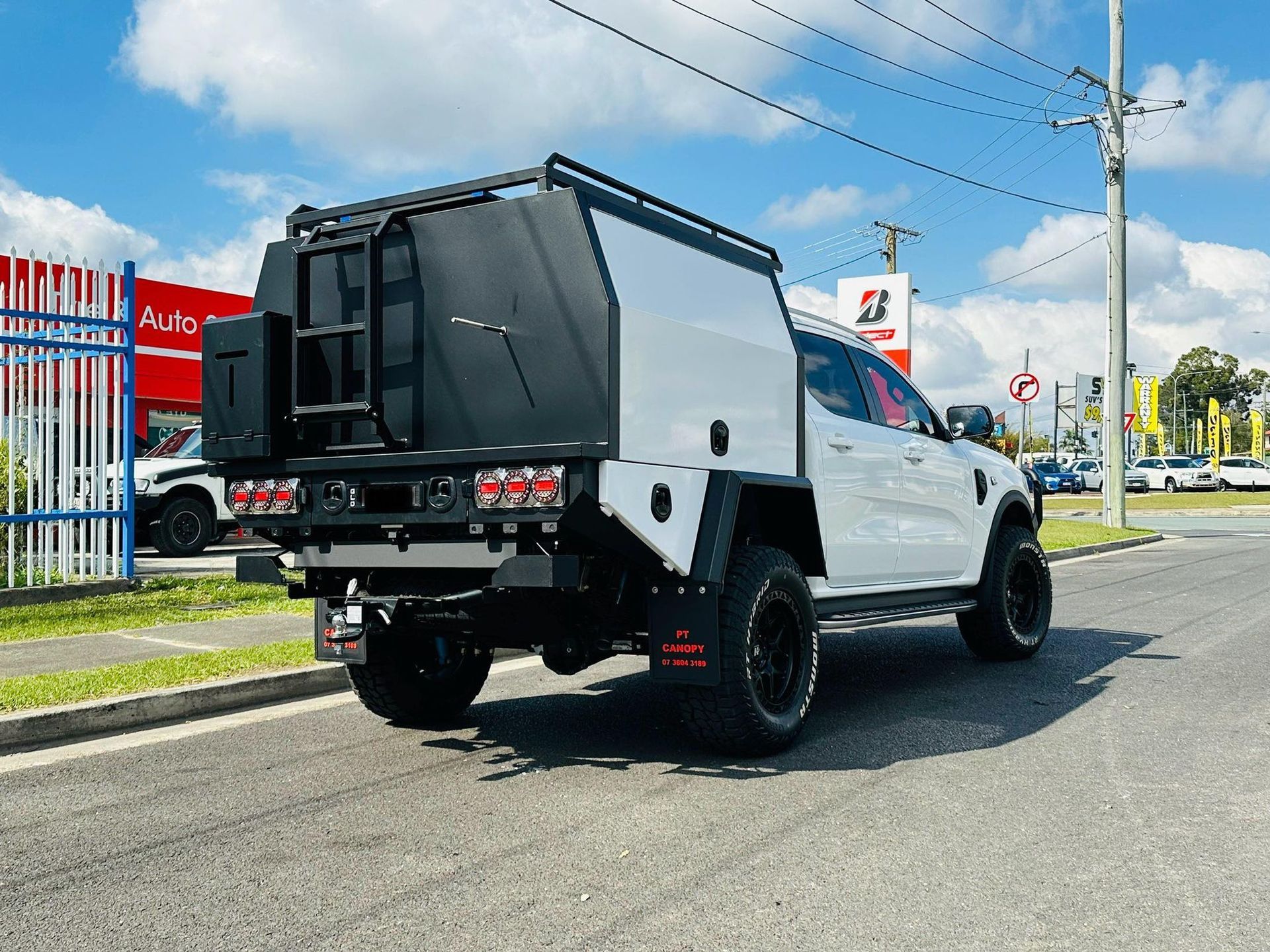 White Pickup Truck With a Black Utility Canopy Parked on a Road — PT Canopy In Slacks Creek, QLD
