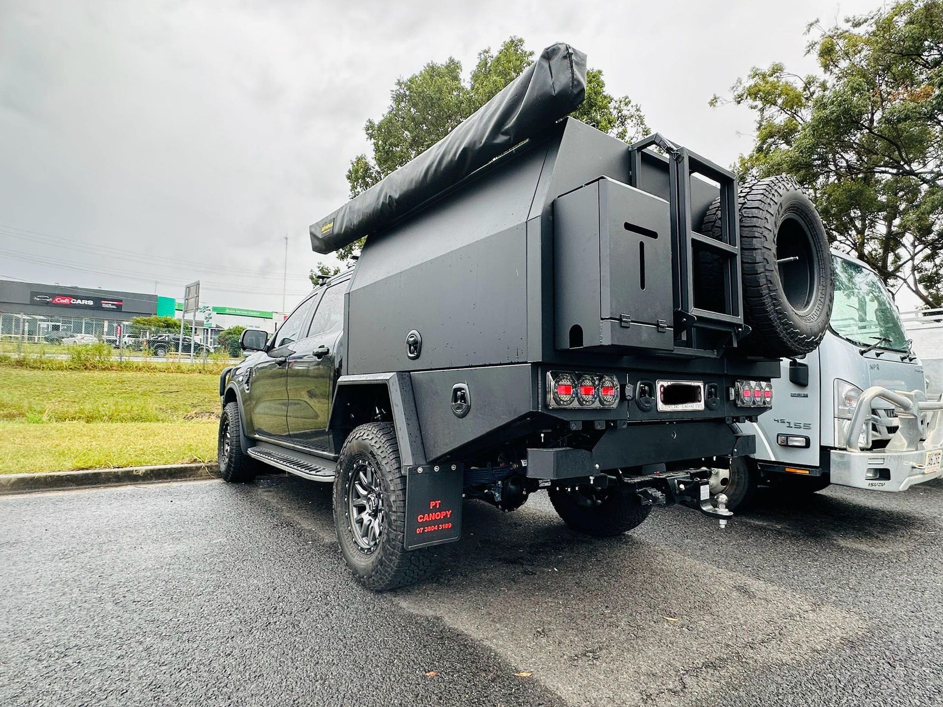 Black Modified Truck With a Camper Setup and Spare Tire — PT Canopy In Slacks Creek, QLD