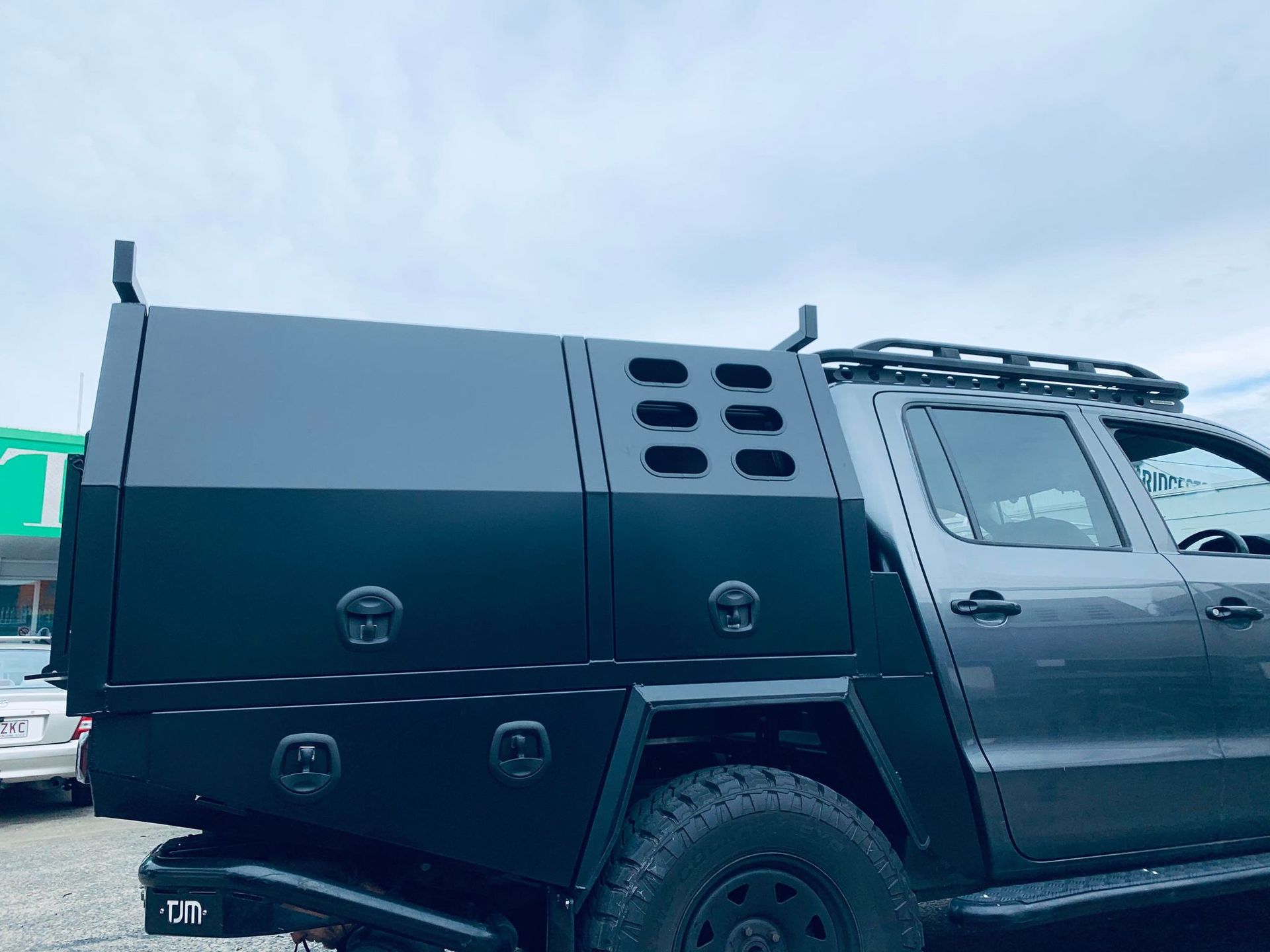 Dark Gray Pickup Truck With a Black Utility Bed Featuring Ventilation Holes and a Roof Rack — PT Canopy In Slacks Creek, QLD