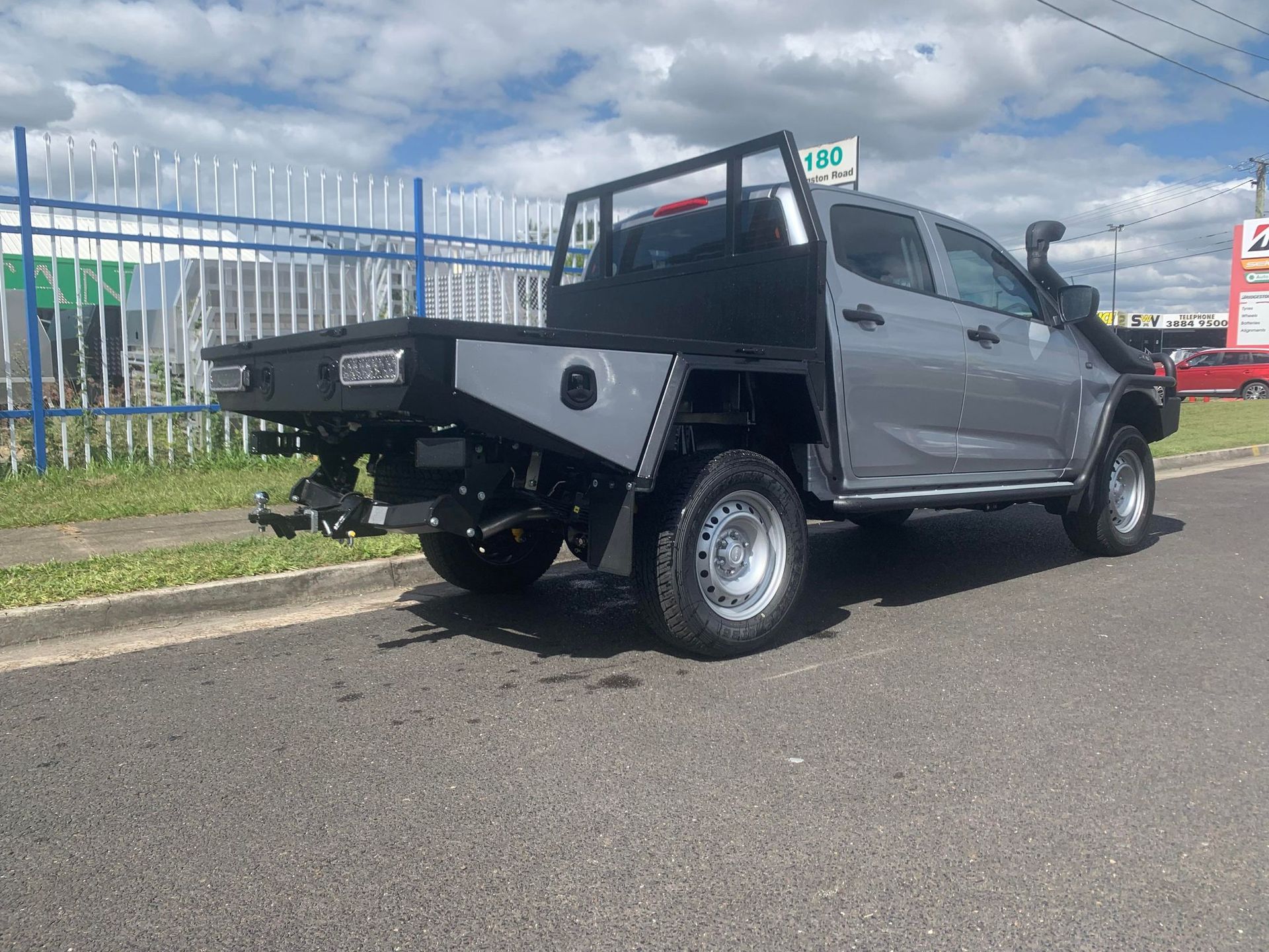 Gray Utility Truck With a Flatbed and Roll Bar Parked on the Street — PT Canopy In Slacks Creek, QLD