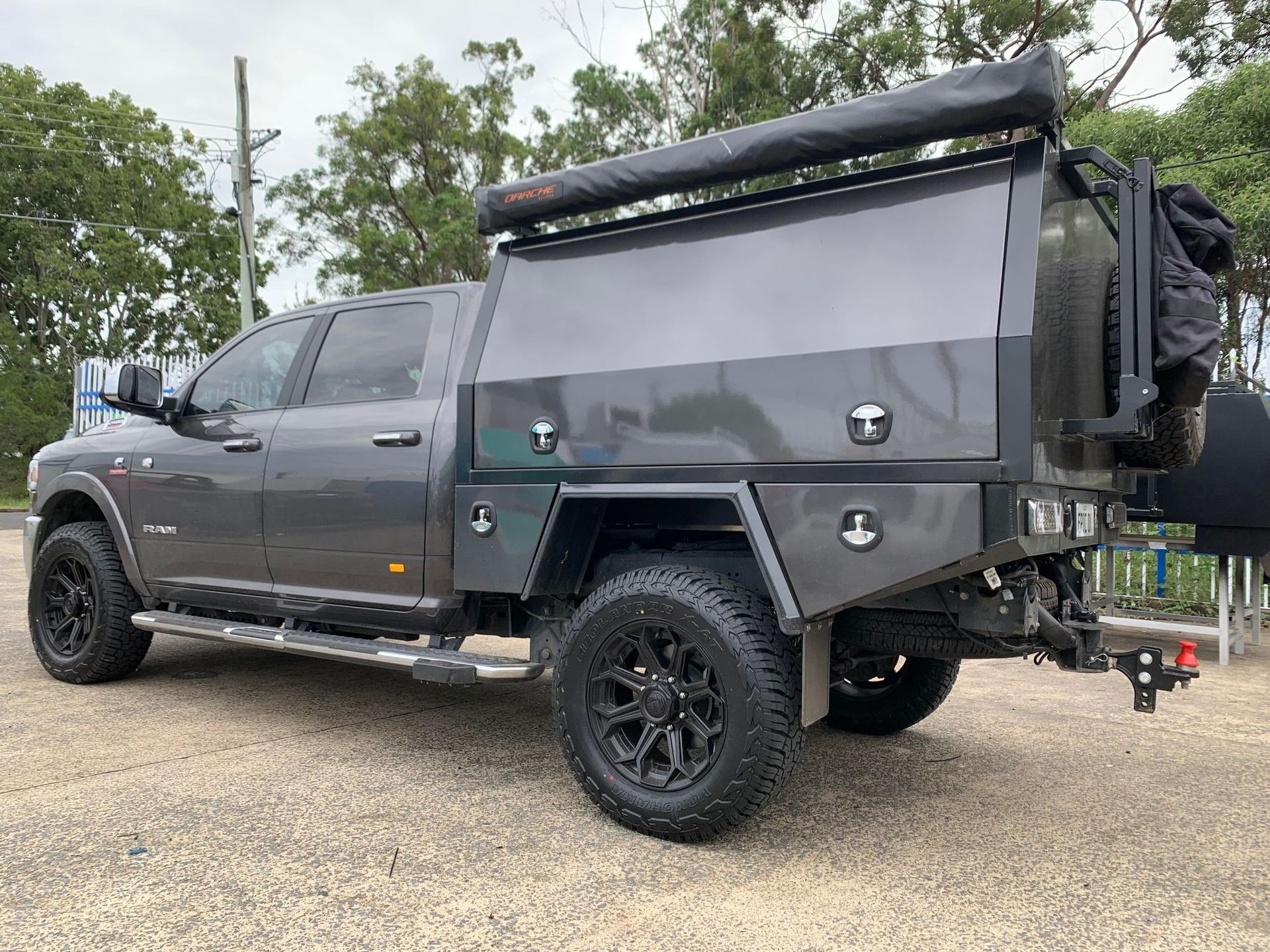 Dark Gray Ram Pickup Truck With a Utility Body, Black Wheels and an Awning — PT Canopy In Sunshine Coast, QLD