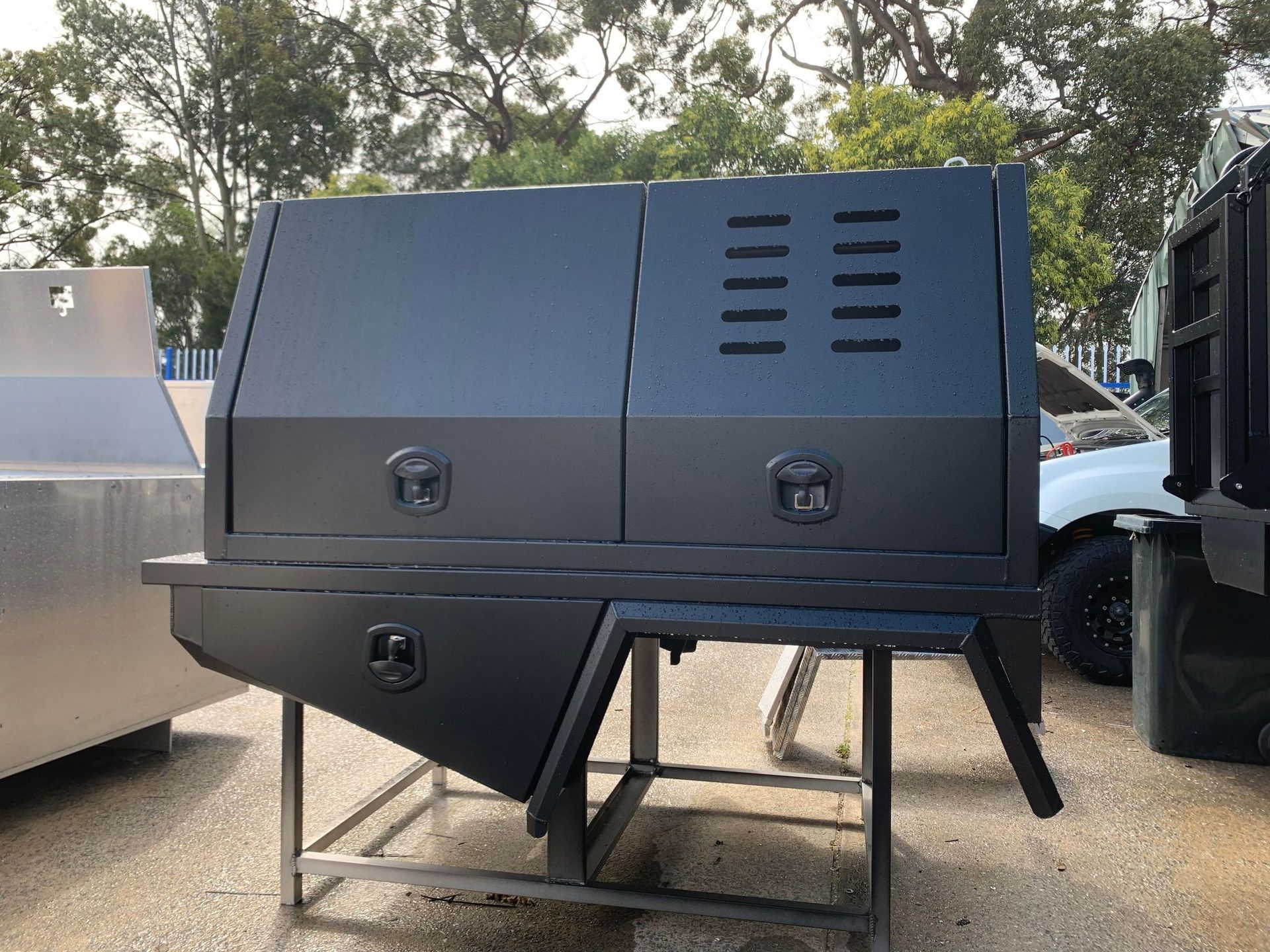 Dark Gray Truck Bed With Storage Compartments and Ventilation Slots — PT Canopy In Gold Coast, QLD