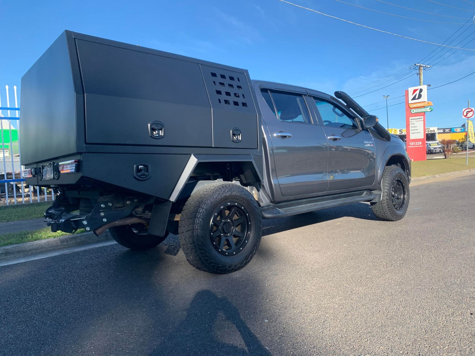Gray Pickup Truck With a Black Utility Bed and Black Wheels Parked on Asphalt Next to a Road — PT Canopy In Slacks Creek, QLD