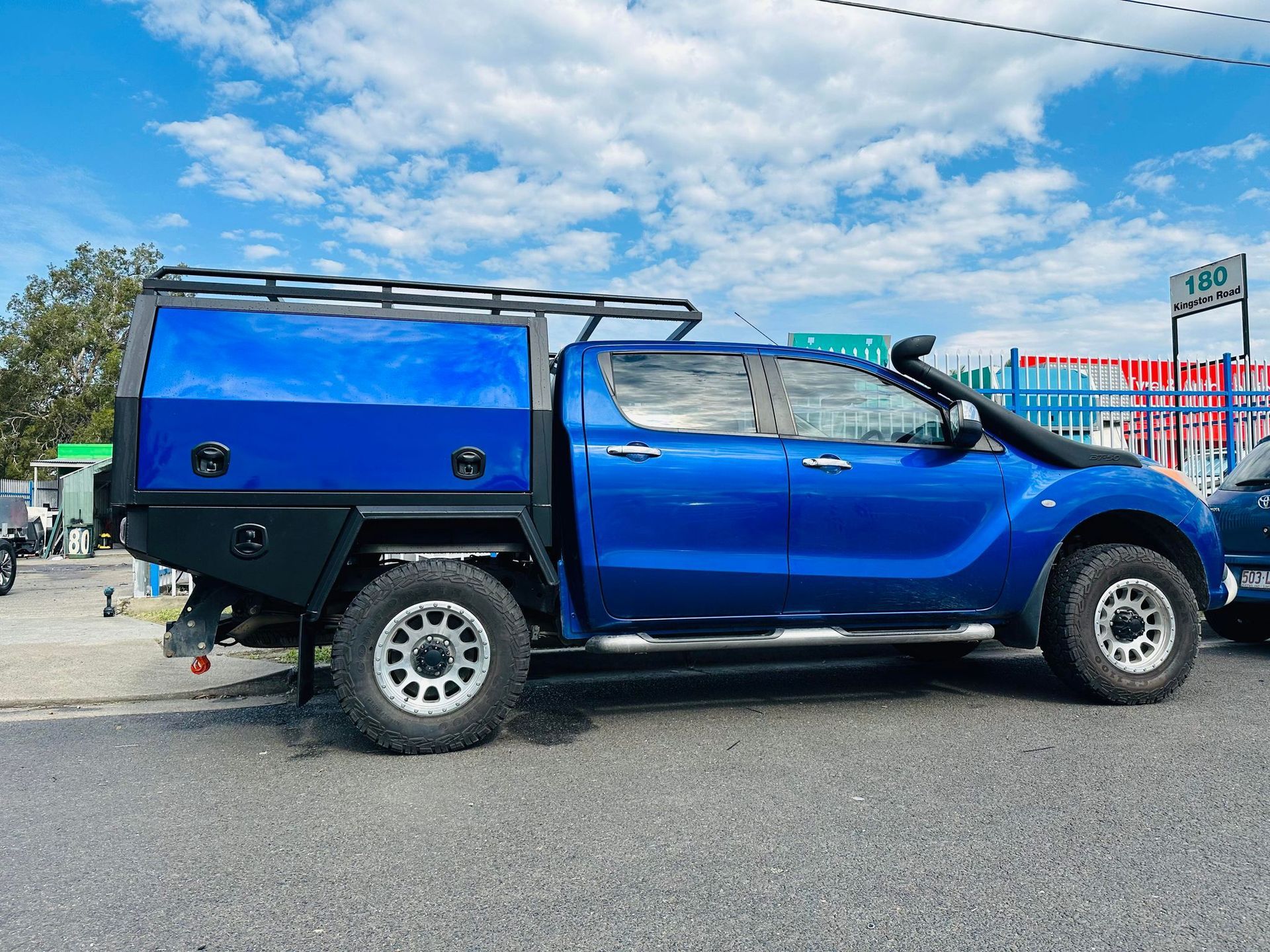 Blue Pickup Truck With a Black Tray and Canopy Parked on a Road — PT Canopy In Slacks Creek, QLD