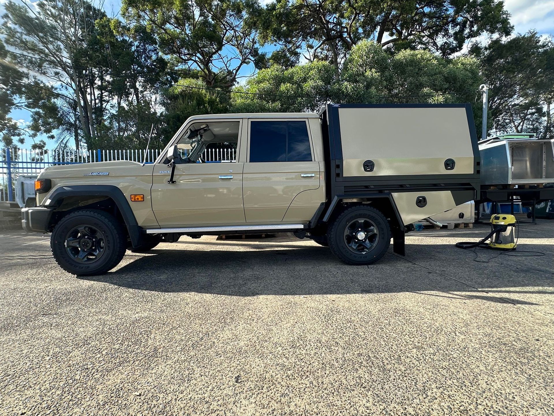 Tan Toyota Land Cruiser pickup truck with a utility box — PT Canopy In Slacks Creek, QLD