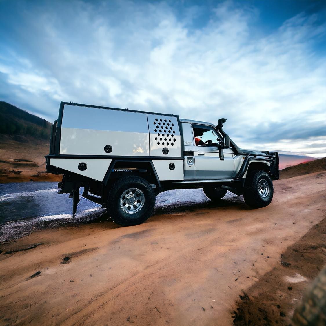 Off-Road Vehicle With a Custom Utility Bed Driving on a Dirt Road — PT Canopy In Slacks Creek, QLD