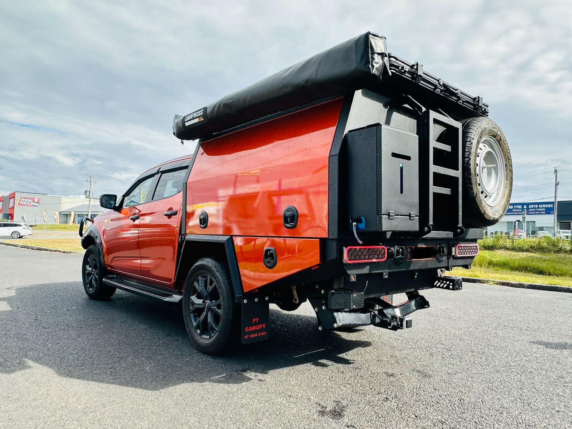 Red Pickup Truck With a Custom Camper Shell and Black Wheels, Parked on a Road — PT Canopy In Slacks Creek, QLD