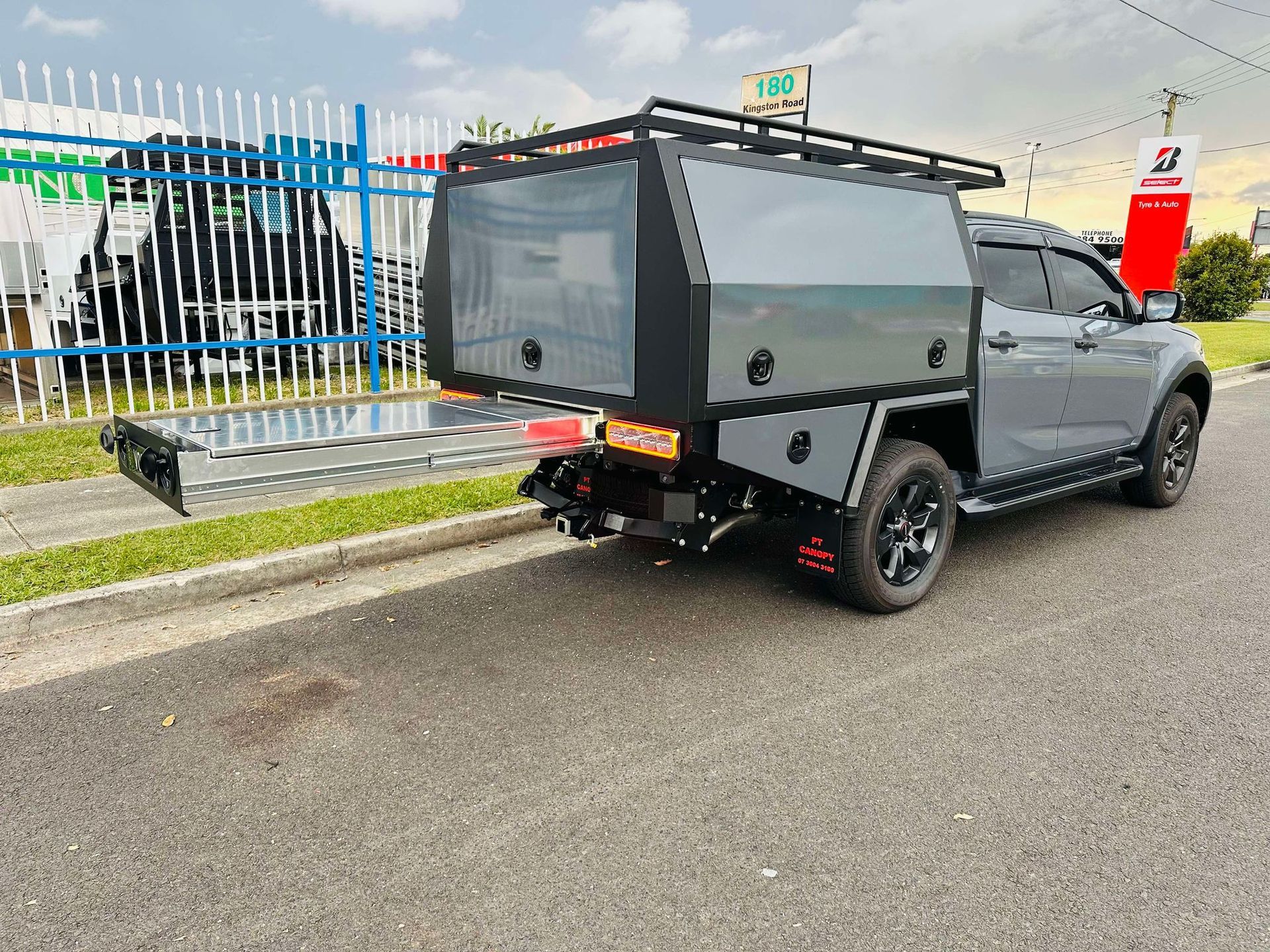 Gray Utility Truck With a Black Canopy and Roof Rack Parked — PT Canopy In Slacks Creek, QLD