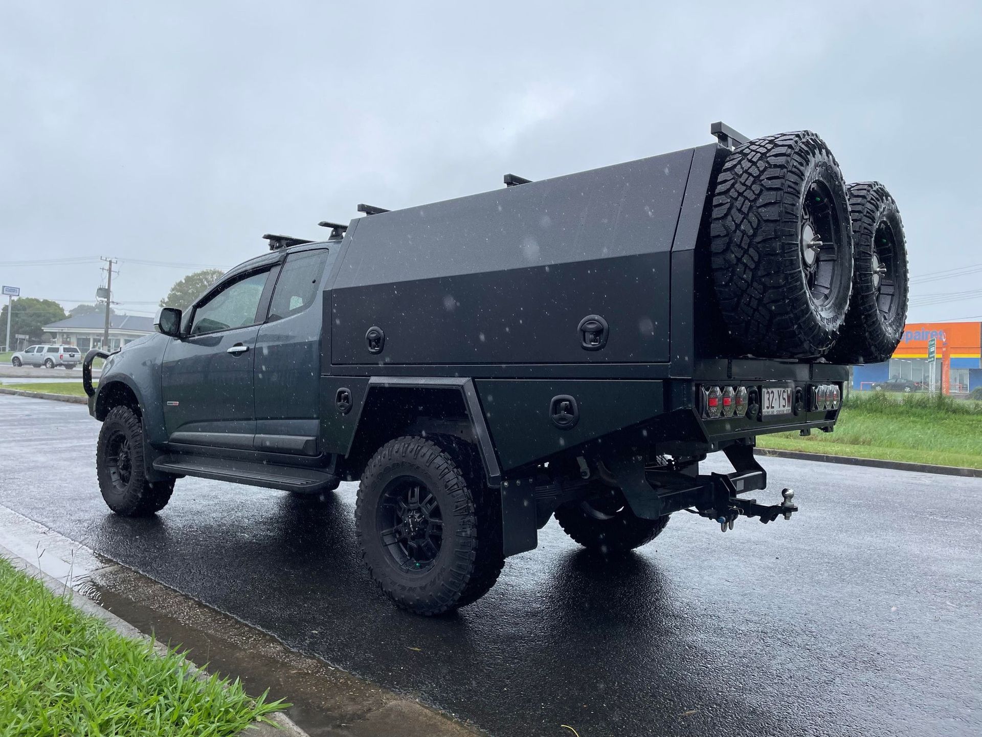 Dark Green Truck With a Utility Body and Spare Tires Mounted on the Back — PT Canopy In Slacks Creek, QLD